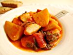 Casserole celery roots with potatoes and grape juice syrup